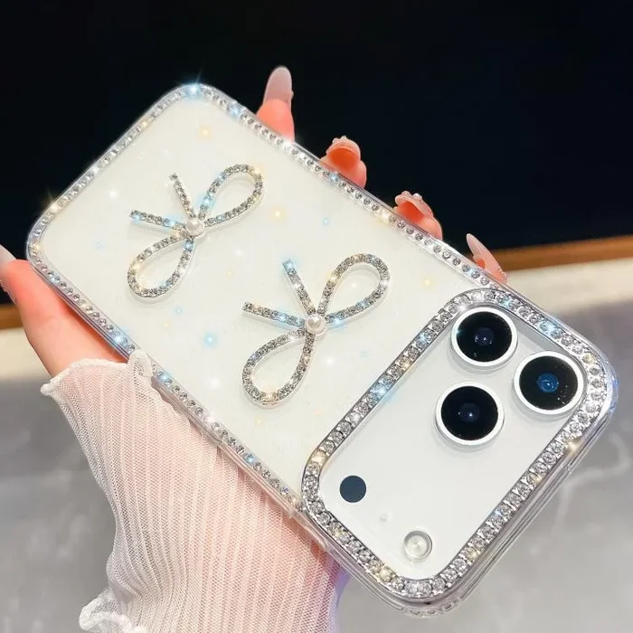 Funda antigolpes con lazo doble y purpurina de diamante para iPhone 17 Pro Max (blanca)